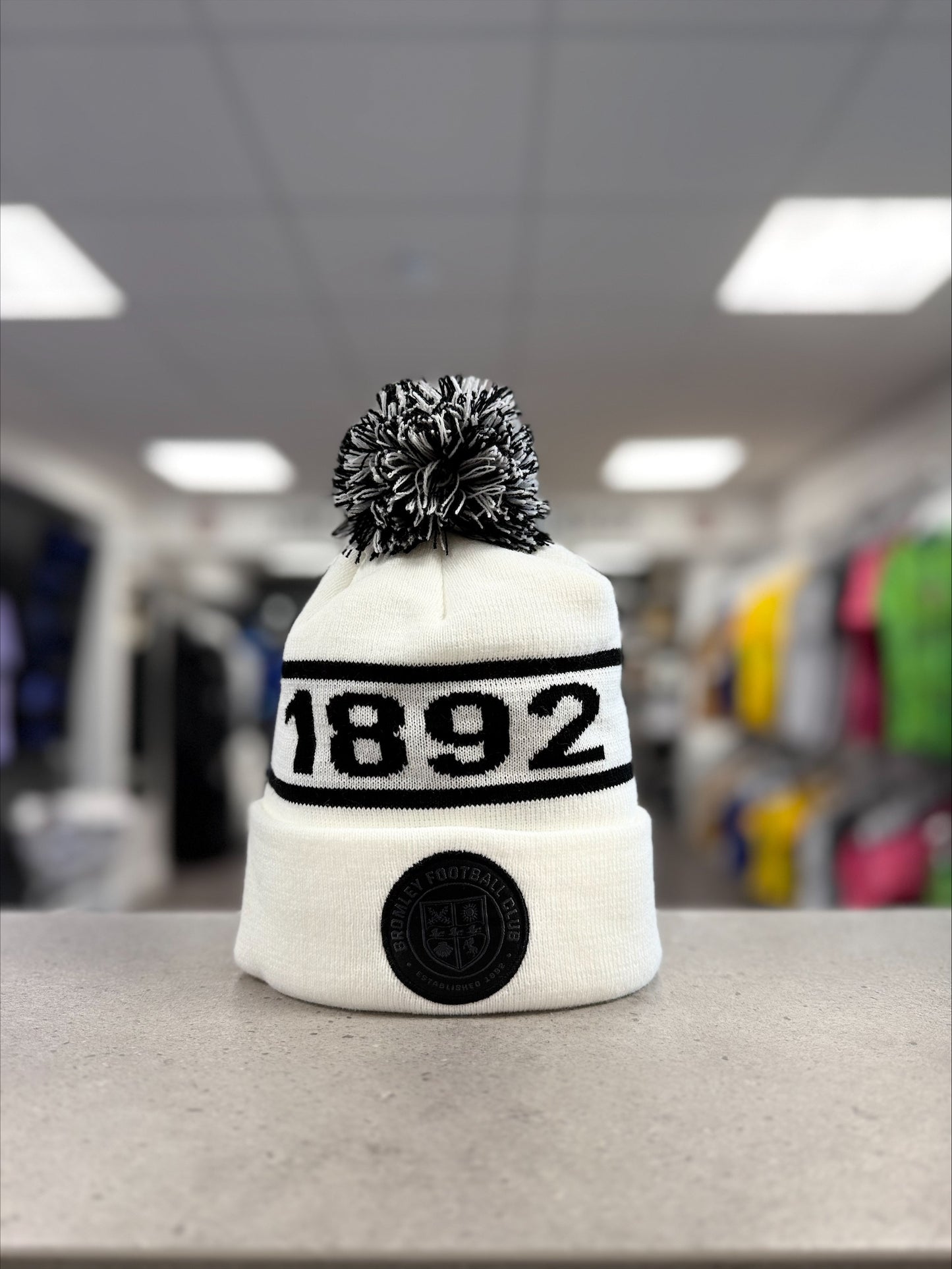 White and black 1892 bobble hats